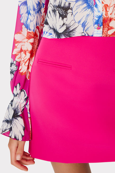 Close-up detail of pink mini skirt with floral top - Waist Detail | MILLY