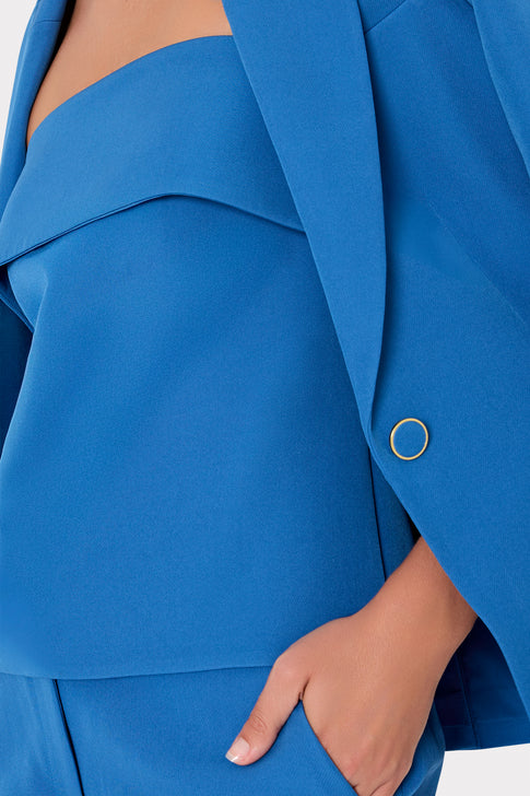 Close-up classic blue cady fabric detail with hand touching elegant suit texture | MILLY