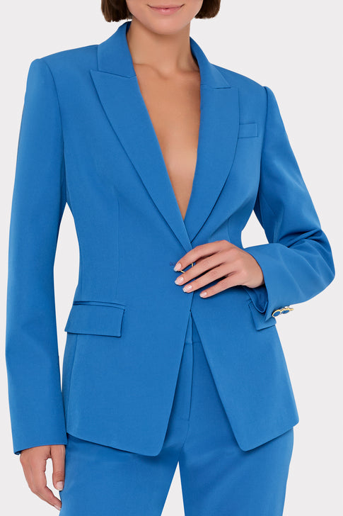 Blue suit jacket worn by a model on a white background