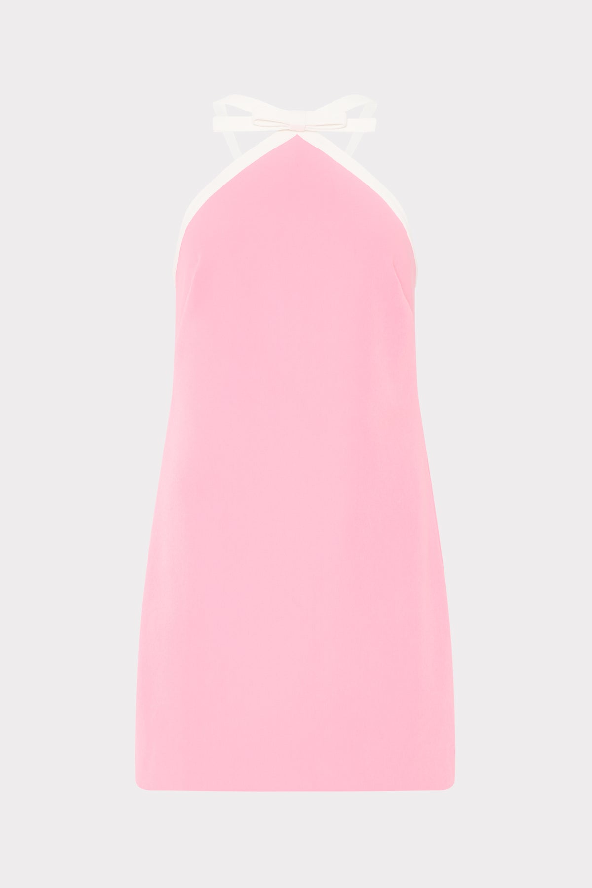 Pink slip dress with a white strap on a light gray background