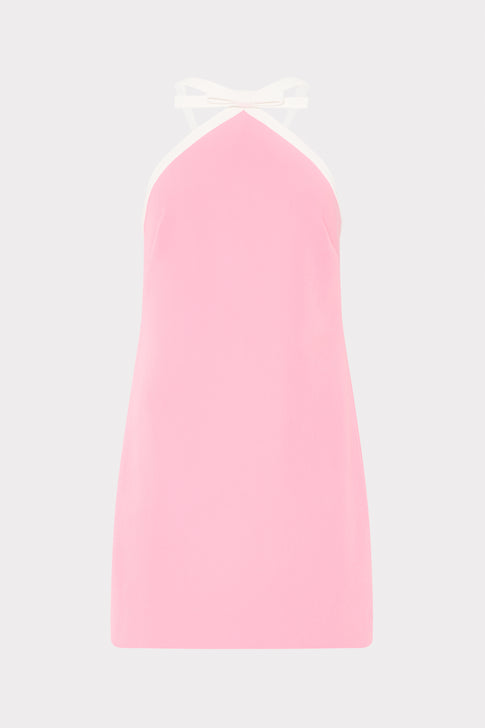 Pink slip dress with a white strap on a light gray background