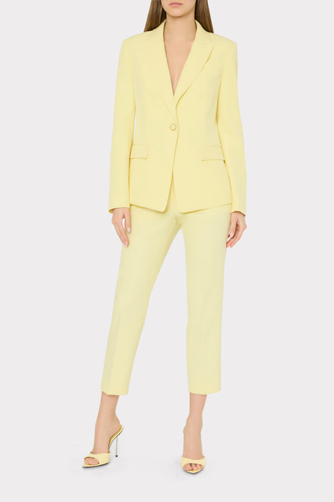 Woman wearing a light yellow suit on a white background