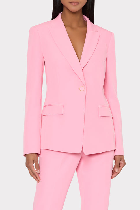 Pink suit worn by a model on a white background