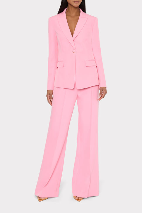 Person wearing a pink suit on a white background