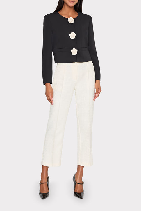 Model wearing black Selena Applique Cropped Jacket with floral details and white pants - Front View | MILLY