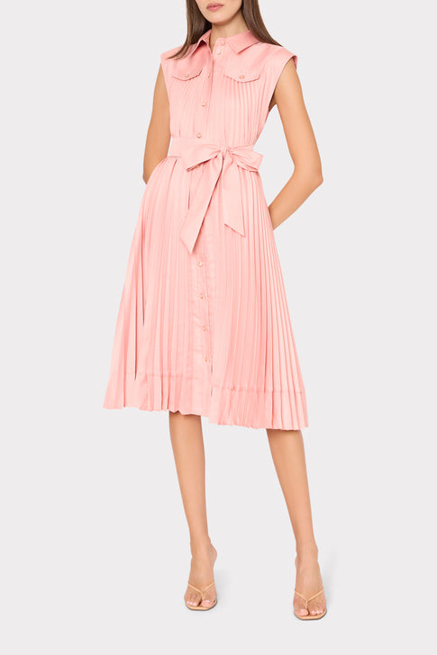 Woman wearing a pink pleated dress on a white background
