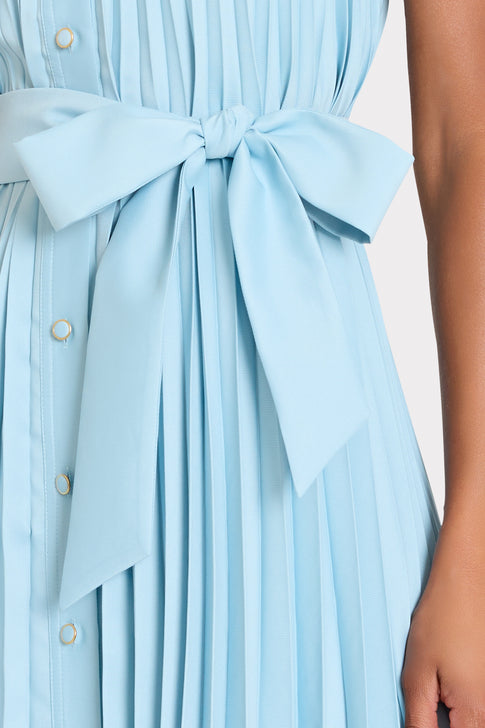 Light blue dress with a large bow detail on a white background