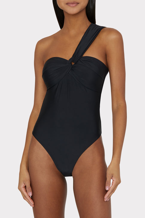 Black swimsuit with unique convertible strap styling worn as one shoulder - Side Angle View | MILLY