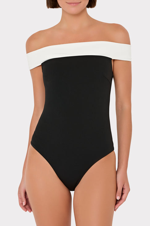 Black and white off-shoulder swimsuit on a plain background
