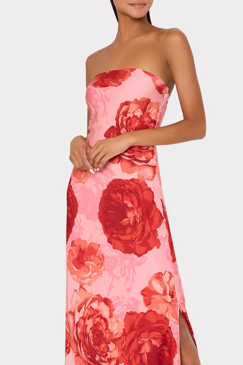 Model wearing designer strapless dress with bold red floral pattern - Three Quarter View | MILLY