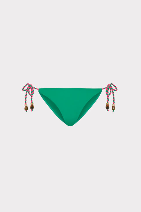 Green designer bikini bottom with colorful rope ties and bead details - Flat Lay | MILLY