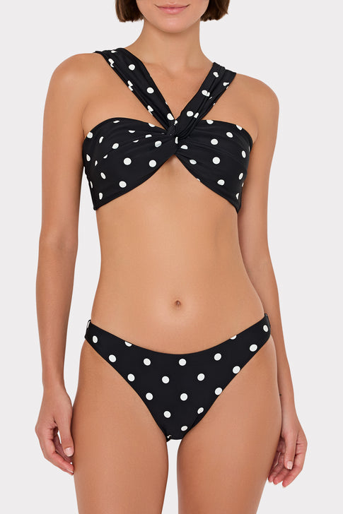 Black bikini with white polka dots featuring a knot design on a white background