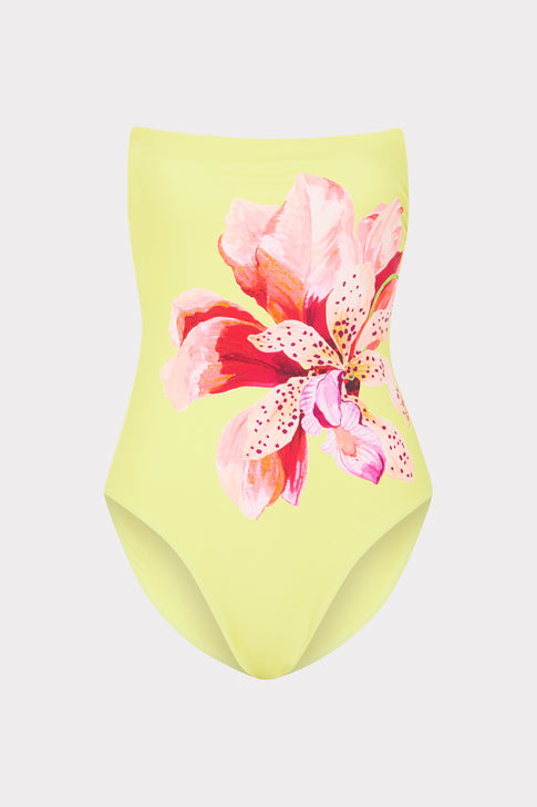 Yellow swimsuit with pink floral design on a light gray background