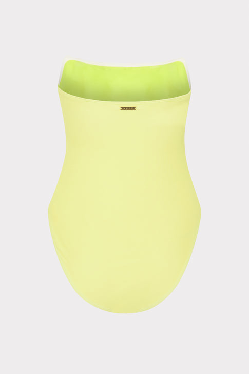 Yellow strapless one-piece on a light gray background