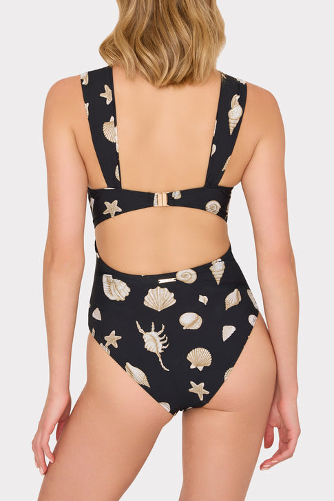 Woman wearing a black one piece with shell pattern - Back Strap Detail | MILLY