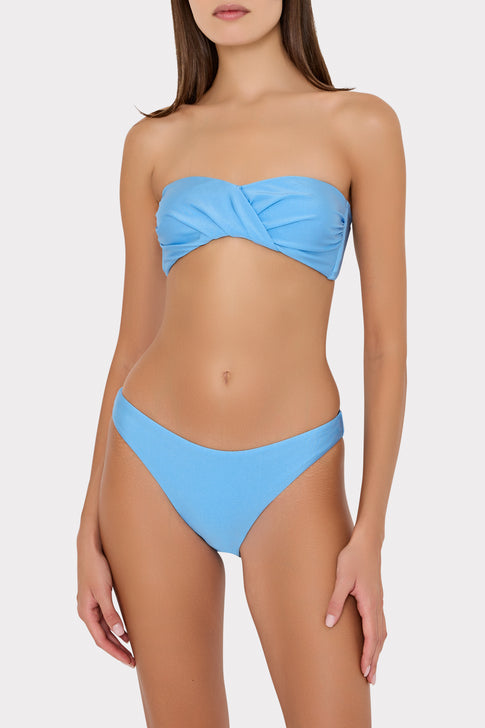 Woman wearing a blue bikini on a white background