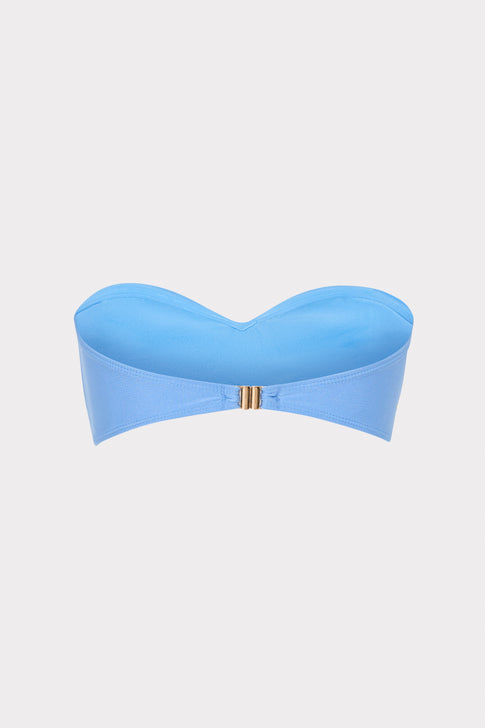 Blue strapless top on a light gray background