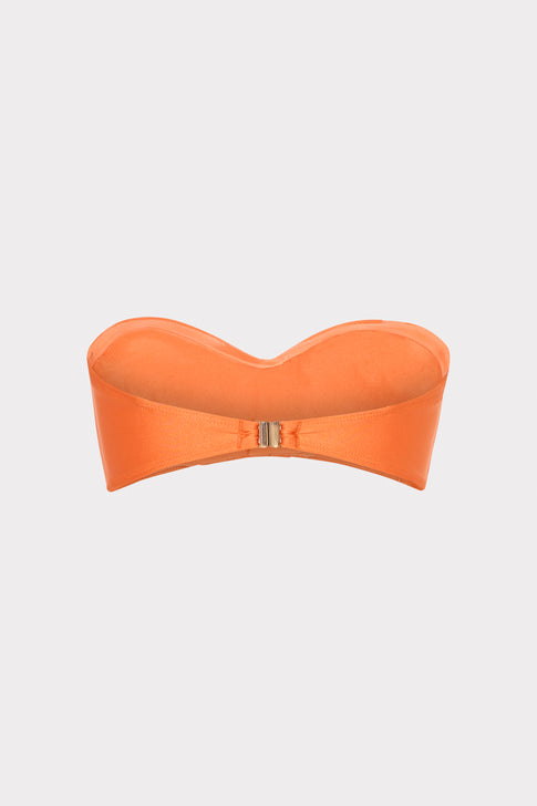 Orange strapless top on a light gray background