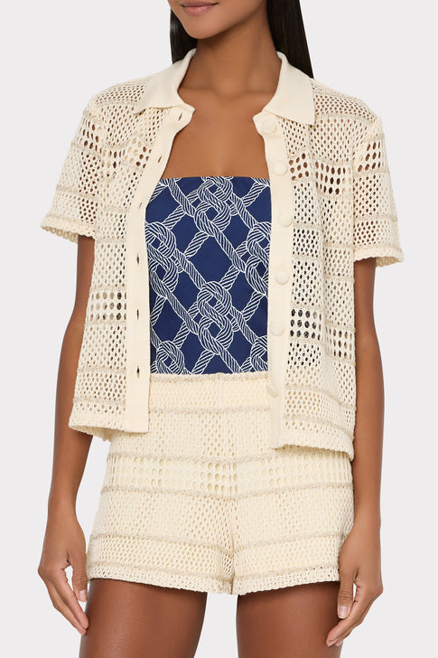 Model wearing cream crochet top with navy printed swimsuit underneath - Beach Styling | MILLY