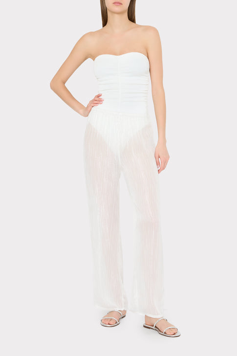 Model wearing white strapless swimsuit with sheer white pinstripe cover-up pants - Front View | MILLY