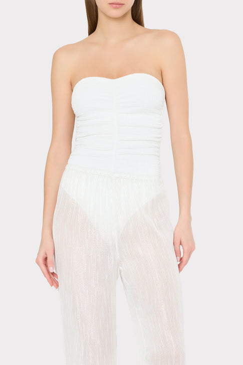 Model wearing white strapless swimsuit with sheer pinstripe cover-up pants - Front Portrait | MILLY