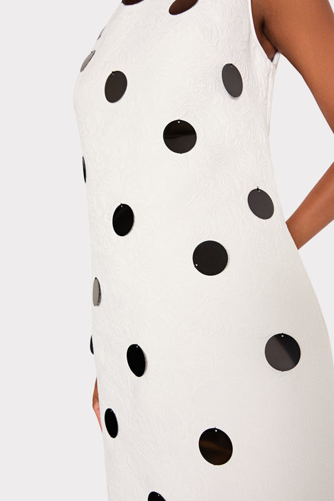 White dress with black polka dots on a white background