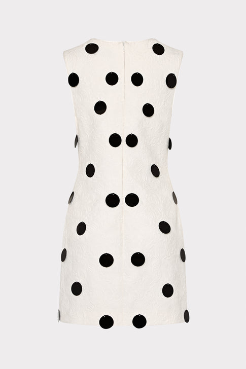 White dress with black polka dots on a white background