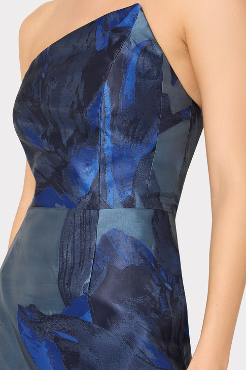 Blue one-shoulder dress with abstract pattern on a white background