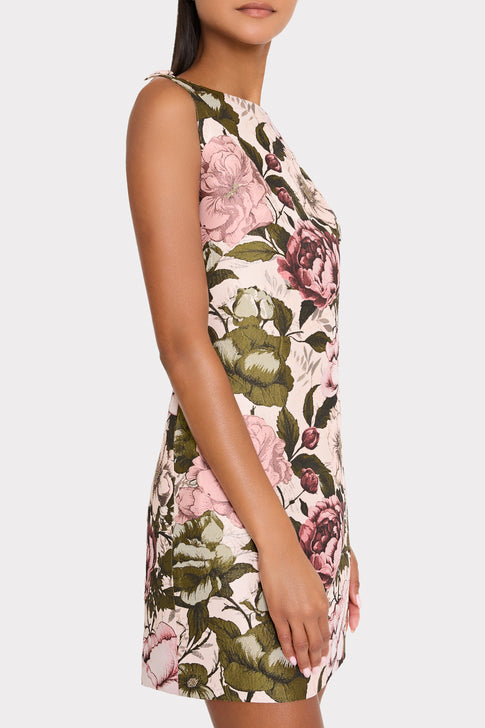 mini multi-colored floral dress on plain background.