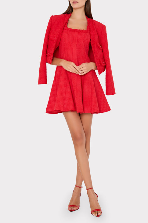 Woman wearing a red dress and jacket set on a white background