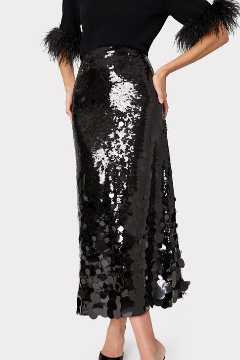 Black sequin skirt worn by a person on a white background