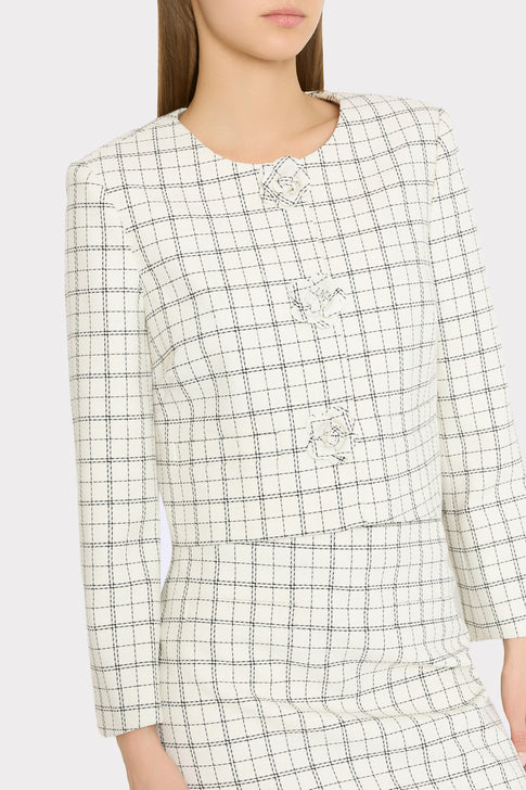 Model wearing elegant checkered plaid outfit with unique floral buttons | MILLY
