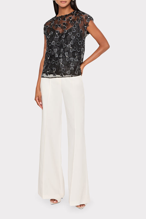 Black Organza Ryan Top Styled with White Pants - Front View | MILLY