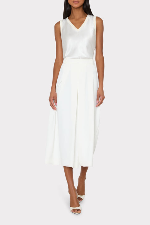 Woman wearing white Satin Knit V-Neck Shell Top and culottes - Styled Look | MILLY