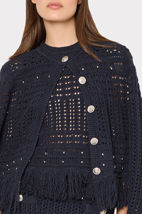 Navy blue crochet jacket with button details on a plain background