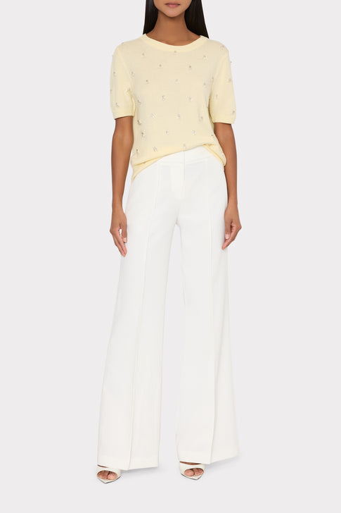 Model wearing light yellow rhinestone embellished sweater and white pants - Full Body | MILLY