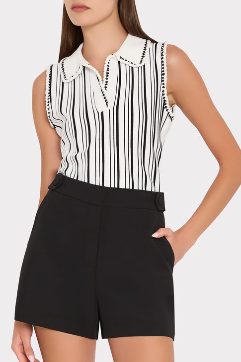 Woman wearing black and white striped sleeveless top with collar and black shorts - Side Profile | MILLY