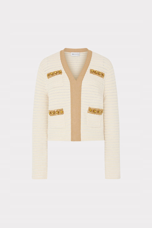Cream-colored cardigan with gold accents on a light gray background